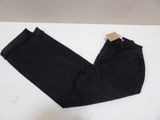 a pair of black jeans sitting on top of a white table