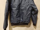 a blue jacket hanging on a hanger on a wall