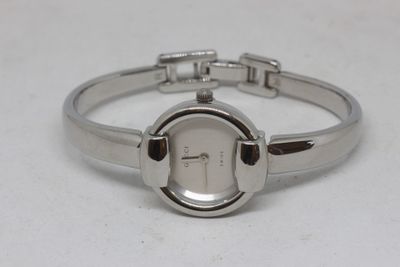 an image of a close up of a wrist watch on a white surface