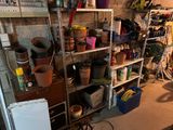 many pots and pans on the shelves in the garage