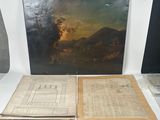 two books on a table with a picture of a landscape