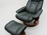 a black leather recliner chair and ottoman on a white background