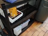 a black shelf with a blue bag on top of it