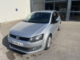 the silver volkswagen polo is parked in front of a building
