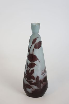a glass vase with a brown and white design on it