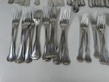many forks and spoons laid out on a table