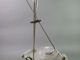 a glass bowl with a handle and a pair of crutches on it