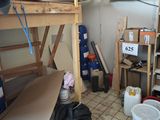 a room with a bunk bed and a shelf with boxes on it