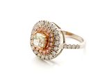 a close up of a pink and white diamond ring on a white background