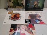 three cd ' s are sitting on a table next to each other