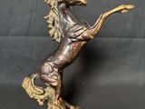 statue of a horse standing on its hind legs on a black background