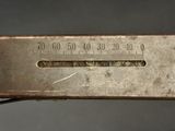 a close up of a metal ruler on a table