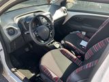 the interior of a small car with two seats and a steering wheel