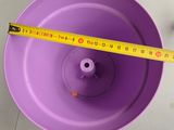 a measuring tape on a purple bowl on a table