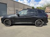 the bmw x3 is parked in front of a building