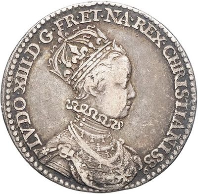 a silver coin with a crown on top of it