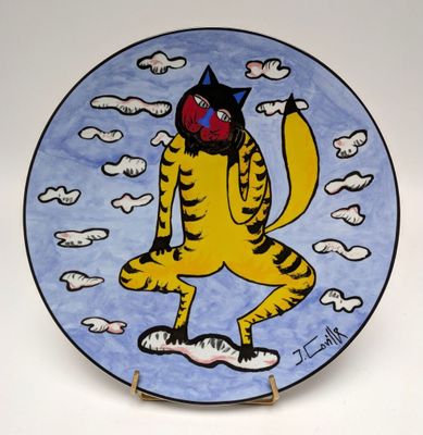 a plate with a painting of a cat on it