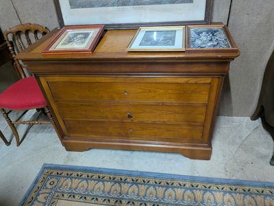 a picture of a dresser with pictures on top of it