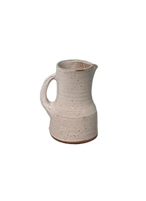 a white pitcher that is sitting on a table