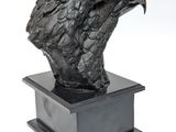 a statue of an eagle on a pedestal with a white background