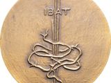 an image of a gold medal with a snake and dagger on it