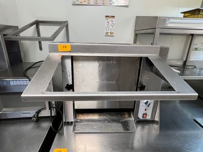 plan de travail en acier inoxydable dans une cuisine professionnelle équipée d'un grand four