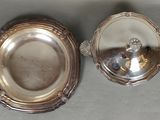 silver plate with a mirror on top of it sitting on a table