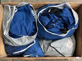 two bags in a wooden box on the floor