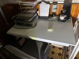 a small desk with a printer on it in a kitchen