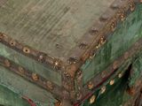 a green trunk sitting on top of a wooden table