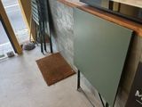 a glass counter with a sign on it in front of a window