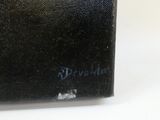 an old book sitting on top of a white table next to a white wall