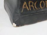a statue of a man sitting on top of a black box
