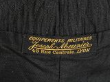a close up of a black jacket with a gold embroidered label on it