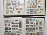 two open books with stamps on them sitting on a table