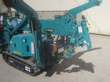 a blue machine that is parked in front of a building