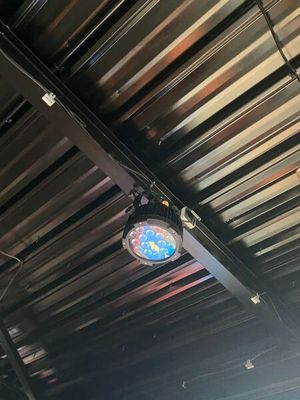 a clock that is hanging from the ceiling of a restaurant