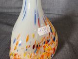 a white vase with a multicolored design on it