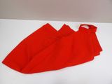 two pieces of red cloth folded on top of each other on a white surface