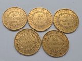 four gold coins with the names of different countries on them