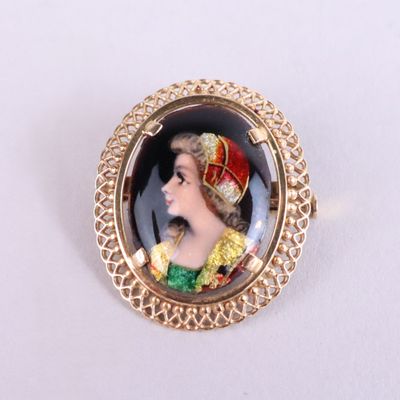 an image of a picture of a woman wearing a crown on a broocher