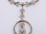 a close up of a necklace with a circular pendant on a chain