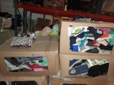 two boxes with clothes on top of them in a warehouse