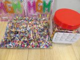 a bag of beads and a jar of beads on a table