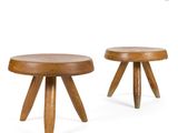 two small wooden stools with wooden legs on a white background
