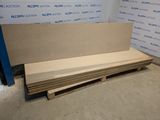 several pieces of plywood are stacked on top of each other in front of a wall