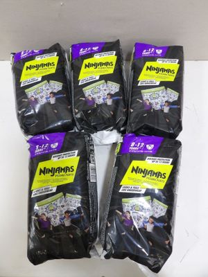 five bags of black bags of food sitting on top of a table