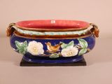 a blue and red bowl with a bird and flowers on it