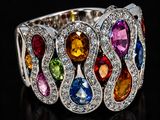 a close up of a multi colored ring on a black surface