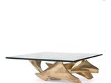 a gold coffee table with a glass top on a white background
